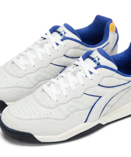 Sneaker Diadora Bianca con Profili Blu e Dettaglio Giallo